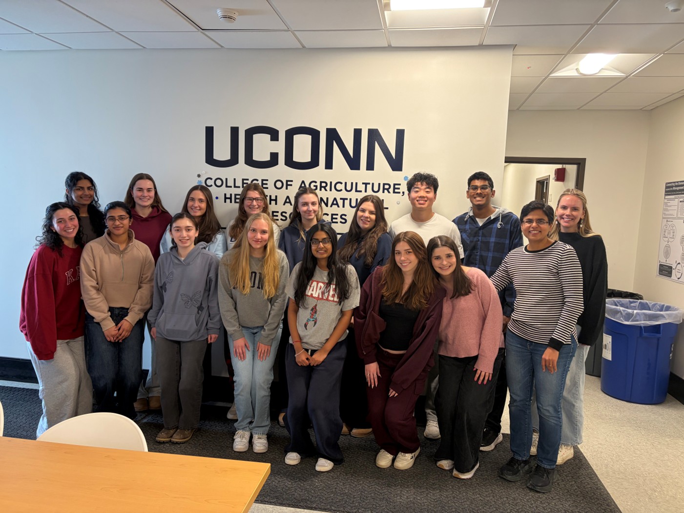 Large group of students in front of a UConn CAHNR sign.