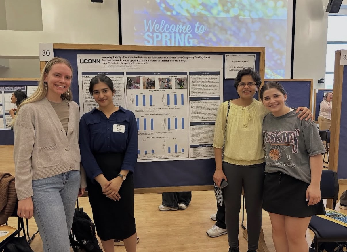 Professor and students standing in front of board